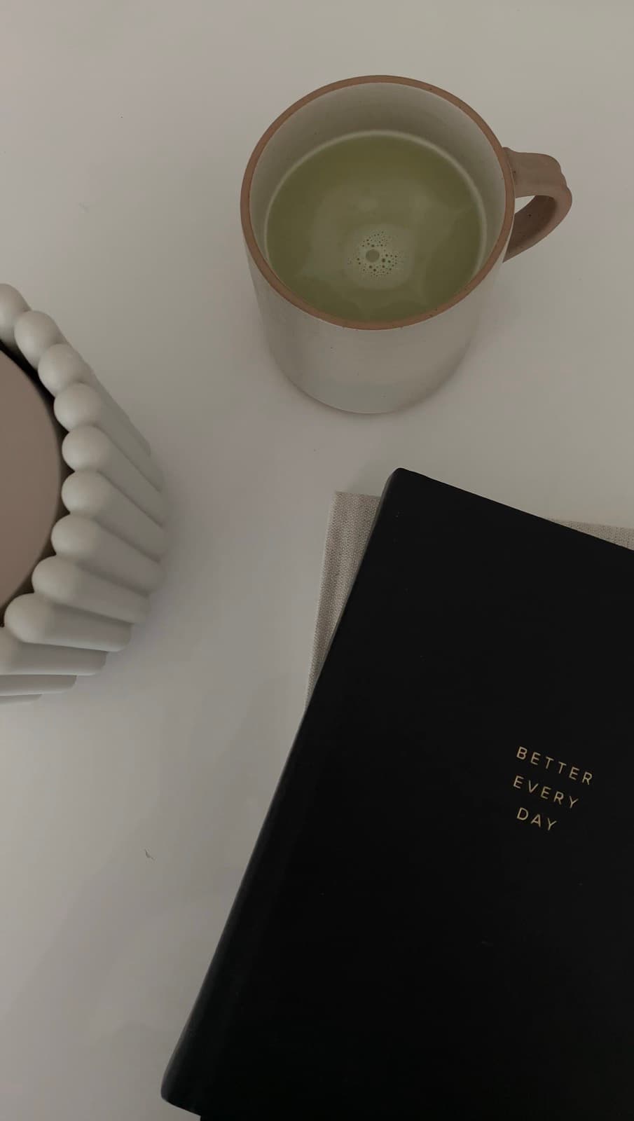 Matcha and a journal on a white table