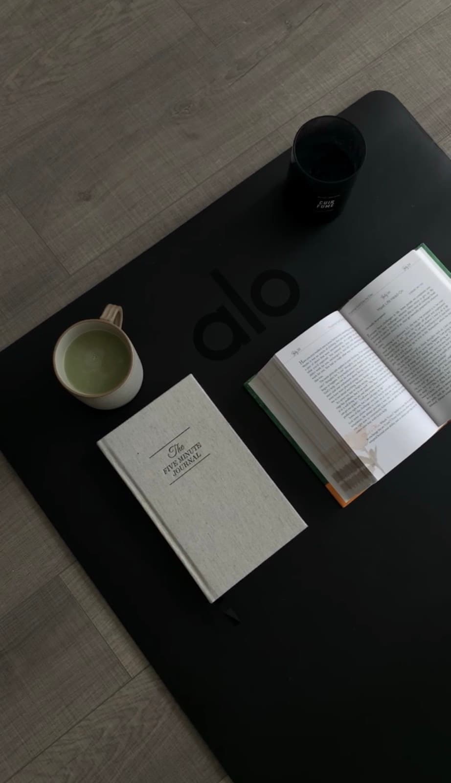 Journal, book and matcha on a yoga mat