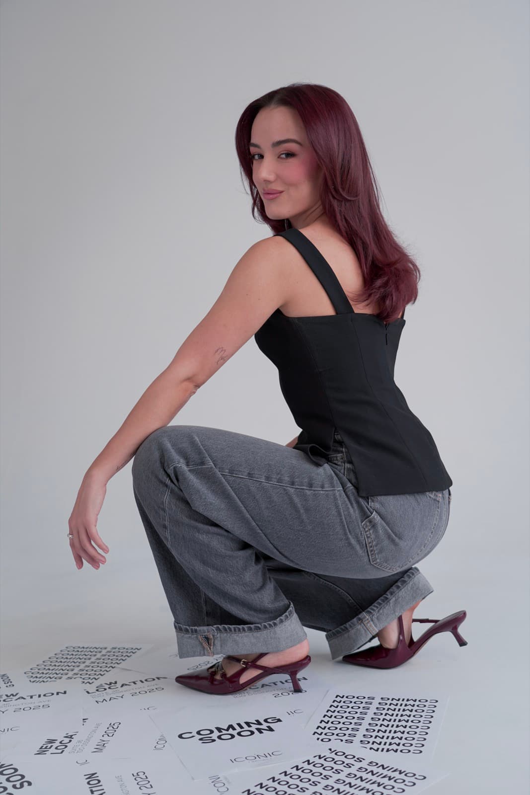 Crouched on the posters, glancing back over her shoulder